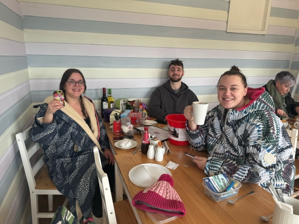friends enjoy a hot drink after cold water swimming at whitmore lake