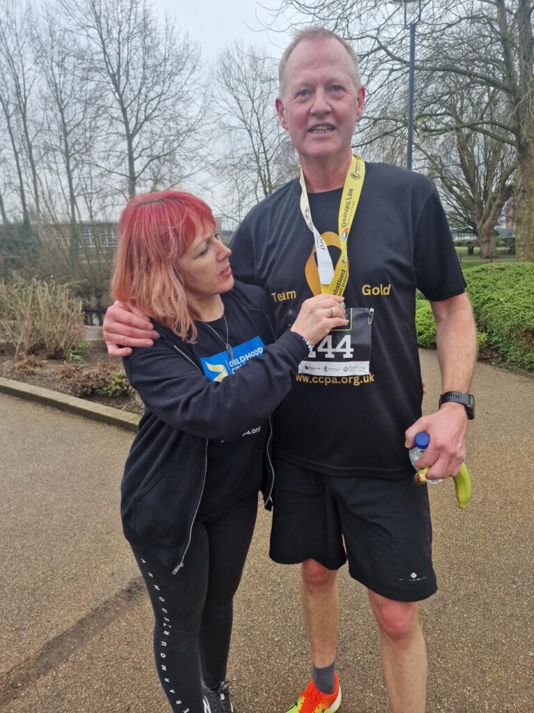 Rachael from CCPA checks Duncan's medal after the half-marathon