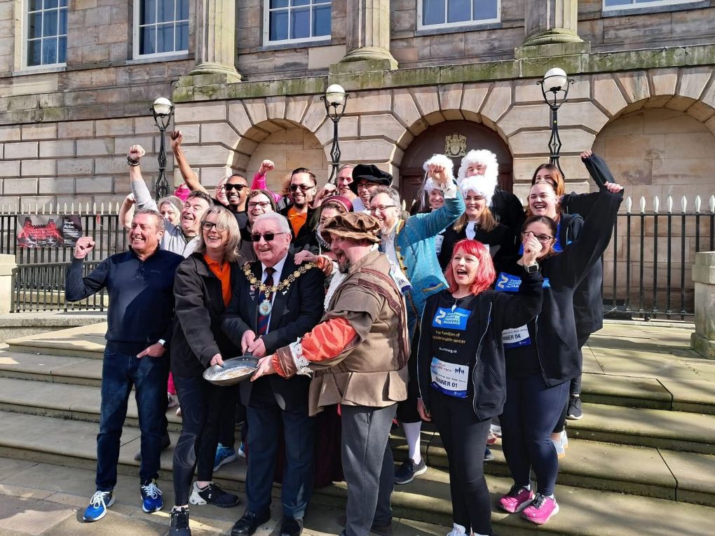 The Mayor stands on the steps of the Shire Hall in Stafford with teams 