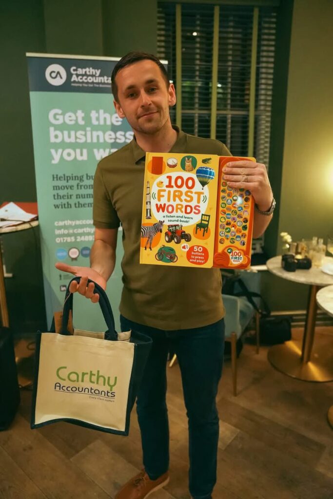 The winner of the 'wooden spoon' poses with his prize at the charity quiz